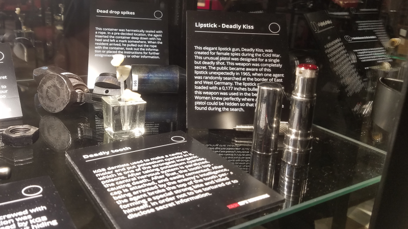 A KGB lipstick tube, actually a tiny firearm—next to a cyanide-filled fake tooth and a spike designed to be stamped into the ground to hide dead drops.